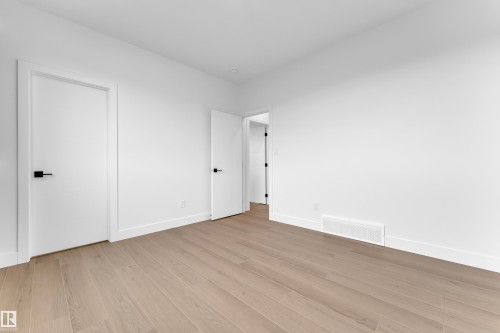 Unfurnished bedroom featuring light wood-style flooring and baseboards - 202 Basin Court, Leduc, AB - Indoor Photo Showing Other Room