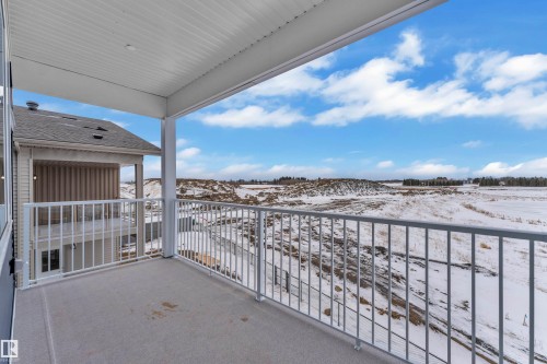 View of snow covered back of property - 202 Basin Court, Leduc, AB - Outdoor With Exterior