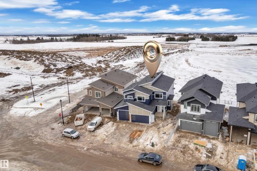Snowy aerial view featuring a residential view - 202 Basin Court, Leduc, AB - Outdoor With View