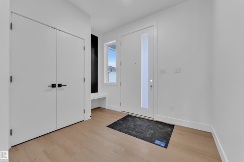 Foyer entrance featuring light wood-style flooring - 202 Basin Court, Leduc, AB - Indoor Photo Showing Other Room