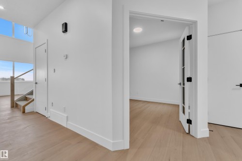 Corridor featuring light wood-type flooring and recessed lighting - 202 Basin Court, Leduc, AB - Indoor Photo Showing Other Room