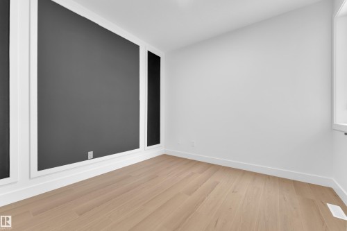 Empty room with light wood-type flooring and baseboards - 202 Basin Court, Leduc, AB - Indoor Photo Showing Other Room