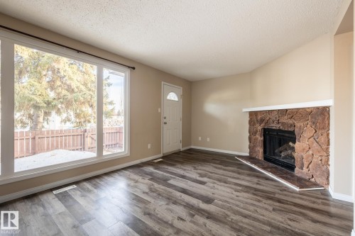 Edmonton, AB - Indoor Photo Showing Living Room With Fireplace