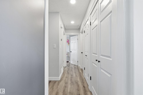 Hallway featuring light wood finished floors, recessed lighting, and a textured ceiling - 848 Millbourne Road E, Edmonton, AB - Indoor Photo Showing Other Room