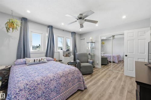 Bedroom featuring two closets, light wood-type flooring, ceiling fan, and recessed lighting - 848 Millbourne Road E, Edmonton, AB - Indoor Photo Showing Bedroom