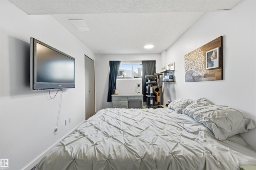 Bedroom with a textured ceiling and a closet - 848 Millbourne Road E, Edmonton, AB - Indoor Photo Showing Bedroom