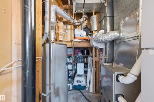Utility room featuring gas water heater and heating unit - 848 Millbourne Road E, Edmonton, AB - Indoor Photo Showing Basement