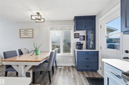 Dining room featuring light wood finished floors and a textured ceiling - 848 Millbourne Road E, Edmonton, AB - Indoor Photo Showing Dining Room