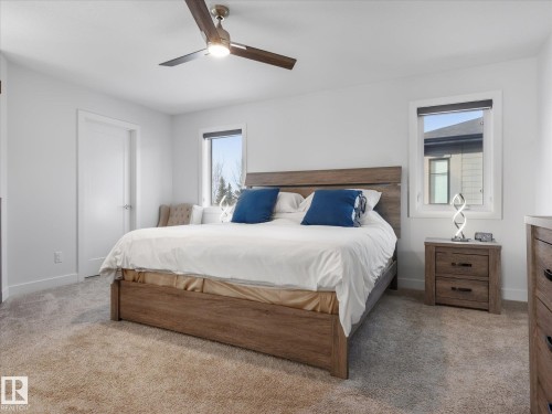 Gorgeous primary bedroom has 2 walk in closets, cozy dual sided gas fireplace and privacy glass. - 1562 Howes Place, Edmonton, AB 