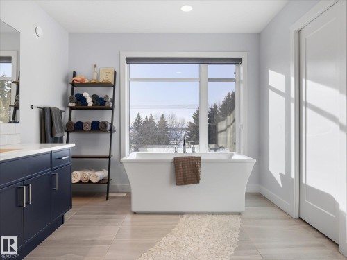 This elegant free standing tub with views of the golf course encourages relaxation, privacy glass ensures your view remains unrestricted. - 1562 Howes Place, Edmonton, AB 