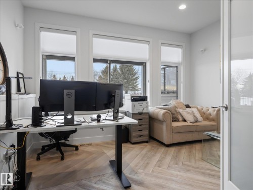 The office is tucked away on the lower level and features herringbone flooring and lots of light. - 1562 Howes Place, Edmonton, AB 
