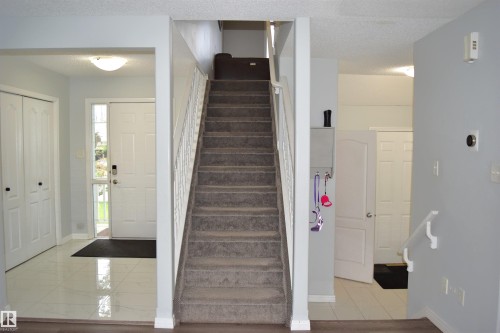 Staircase featuring baseboards and a textured ceiling - 315 Wild Rose Way, Edmonton, AB - Indoor Photo Showing Other Room