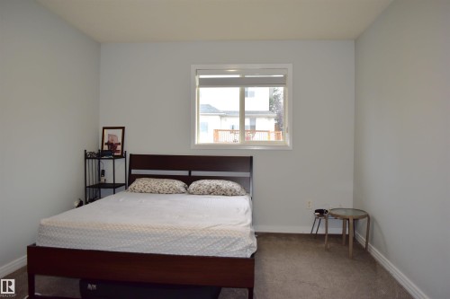 Bedroom featuring dark carpet and baseboards - 315 Wild Rose Way, Edmonton, AB - Indoor Photo Showing Bedroom