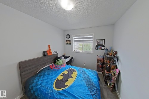 Bedroom with a textured ceiling and carpet flooring - 315 Wild Rose Way, Edmonton, AB - Indoor Photo Showing Bedroom