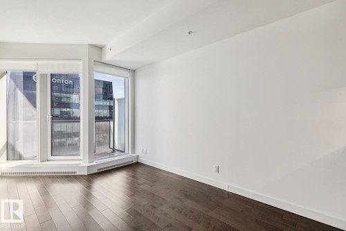 Spare room with dark wood-type flooring and baseboards - 3104 10360 102 Street, Edmonton, AB - Indoor Photo Showing Other Room