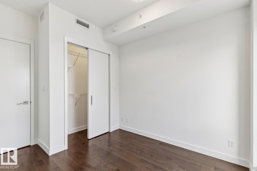 Unfurnished bedroom with dark wood finished floors and a closet - 3104 10360 102 Street, Edmonton, AB - Indoor Photo Showing Other Room