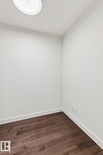 Unfurnished room featuring dark wood-style floors and baseboards - 3104 10360 102 Street, Edmonton, AB - Indoor Photo Showing Other Room