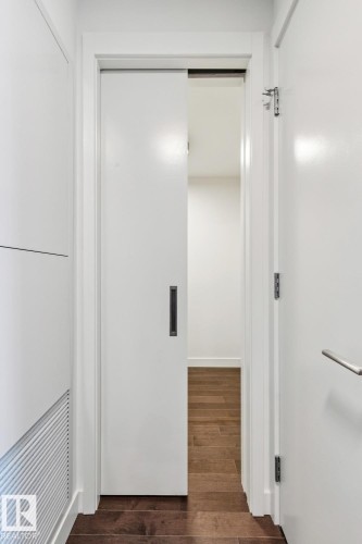 Corridor with dark wood-style floors and baseboards - 3104 10360 102 Street, Edmonton, AB - Indoor Photo Showing Other Room