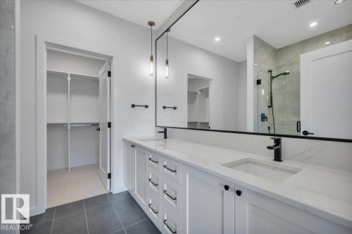 QUARTZ COUNTERS, DUAL SINKS, FULL WALL MIRROR WITH PENDANT LIGHTING AND LARGE WALK IN SHOWER - 322 7459 May Common Nw, Edmonton, AB - Indoor