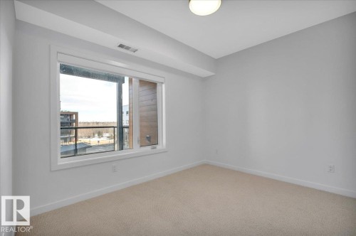 SPACIOUS SECOND BEDROOM - 322 7459 May Common Nw, Edmonton, AB - Indoor Photo Showing Other Room