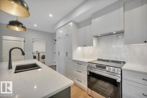 LARGE ISLAND WITH SILGRANITE SINK - 322 7459 May Common Nw, Edmonton, AB - Indoor Photo Showing Kitchen With Double Sink With Upgraded Kitchen
