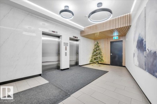 ELEVATORS IN THE ENTRANCE FOYER - 503 10028 119 Street, Edmonton, AB - Indoor Photo Showing Other Room