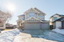 Craftsman-style home featuring stone siding, a garage, and driveway - 3612 Mclay Court, Edmonton, AB  - Outdoor With Facade 