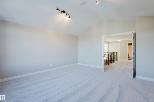 Unfurnished room featuring light carpet and track lighting - 3612 Mclay Court, Edmonton, AB - Indoor Photo Showing Other Room