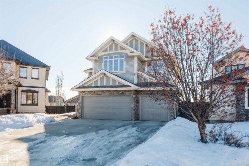 View of front of property with a garage, stone siding, and driveway - 3612 Mclay Court, Edmonton, AB - Outdoor With Facade