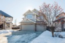 View of front of property with a garage, stone siding, and driveway - 3612 Mclay Court, Edmonton, AB  - Outdoor With Facade 