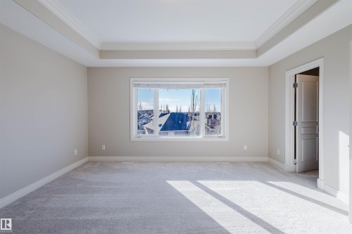 Carpeted empty room with crown molding and a tray ceiling - 3612 Mclay Court, Edmonton, AB - Indoor Photo Showing Other Room