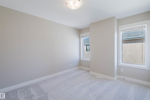 Spare room with light carpet and plenty of natural light - 3612 Mclay Court, Edmonton, AB - Indoor Photo Showing Other Room