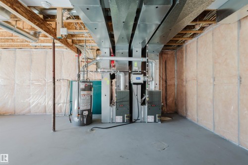 Unfinished below grade area with water heater and heating unit - 3612 Mclay Court, Edmonton, AB - Indoor Photo Showing Basement
