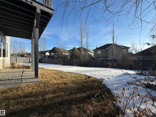 Yard layered in snow featuring a fenced backyard, a patio area, and a residential view - 3612 Mclay Court, Edmonton, AB - Outdoor