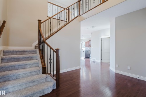 Staircase featuring hardwood / wood-style floors and a high ceiling - 3612 Mclay Court, Edmonton, AB - Indoor Photo Showing Other Room