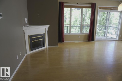 434 10023 110 Street, Edmonton, AB - Indoor Photo Showing Other Room With Fireplace