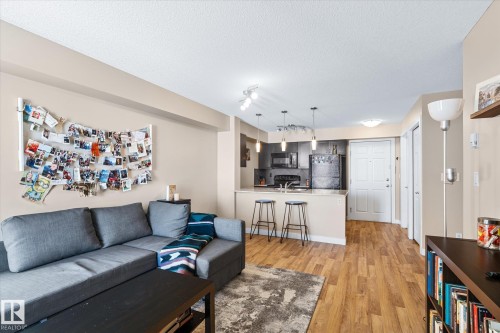 Living room featuring light wood-style flooring, a textured ceiling, and rail lighting - 224 920 156 Street, Edmonton, AB - Indoor Photo Showing Other Room