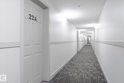 Hall featuring a textured ceiling and dark carpet - 224 920 156 Street, Edmonton, AB - Indoor Photo Showing Other Room