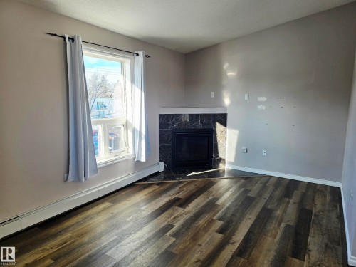 401 10710 116 Street, Edmonton, AB - Indoor Photo Showing Living Room With Fireplace