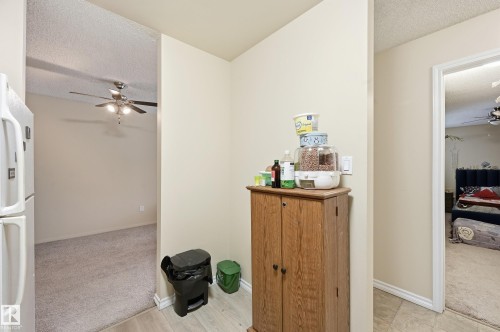 Interior space with a textured ceiling and light carpet - 302 2624 Mill Woods Road E, Edmonton, AB - Indoor