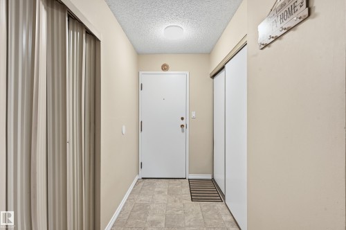 Doorway to outside featuring a textured ceiling and baseboards - 302 2624 Mill Woods Road E, Edmonton, AB - Indoor Photo Showing Other Room
