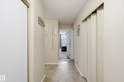 Corridor with baseboards and a textured ceiling - 302 2624 Mill Woods Road E, Edmonton, AB - Indoor Photo Showing Other Room