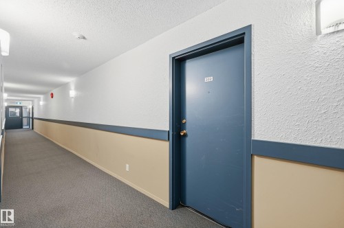 Hall with a textured wall, carpet, and a textured ceiling - 302 2624 Mill Woods Road E, Edmonton, AB - Indoor Photo Showing Other Room