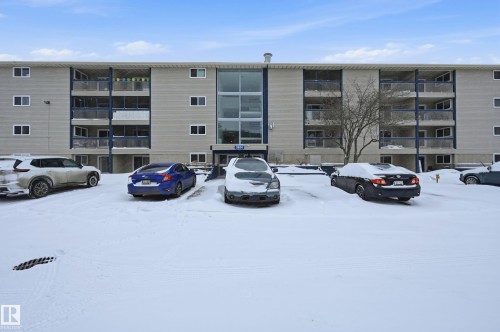 Snow covered building with a view of apartment building / complex and uncovered parking - 302 2624 Mill Woods Road E, Edmonton, AB - Outdoor With Facade