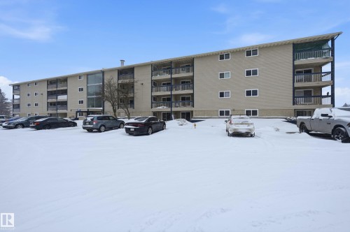 Snow covered property featuring a view of apartment building / complex and uncovered parking - 302 2624 Mill Woods Road E, Edmonton, AB - Outdoor