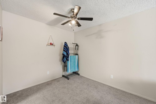 Spare room featuring carpet, a textured ceiling, and a ceiling fan - 302 2624 Mill Woods Road E, Edmonton, AB - Indoor Photo Showing Other Room