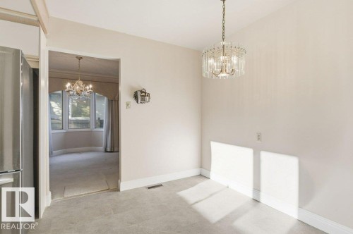Unfurnished dining area with suspended lighting and baseboards - 14335 47 Avenue, Edmonton, AB - Indoor Photo Showing Other Room