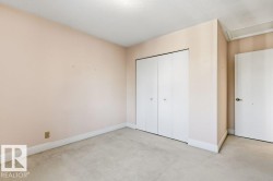 Unfurnished bedroom with light colored carpet, a textured ceiling, and a closet - 