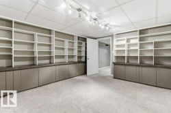 Finished below grade area featuring a drop ceiling and carpet floors - 