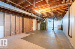 Unfinished below grade area featuring washer / clothes dryer and water heater - 